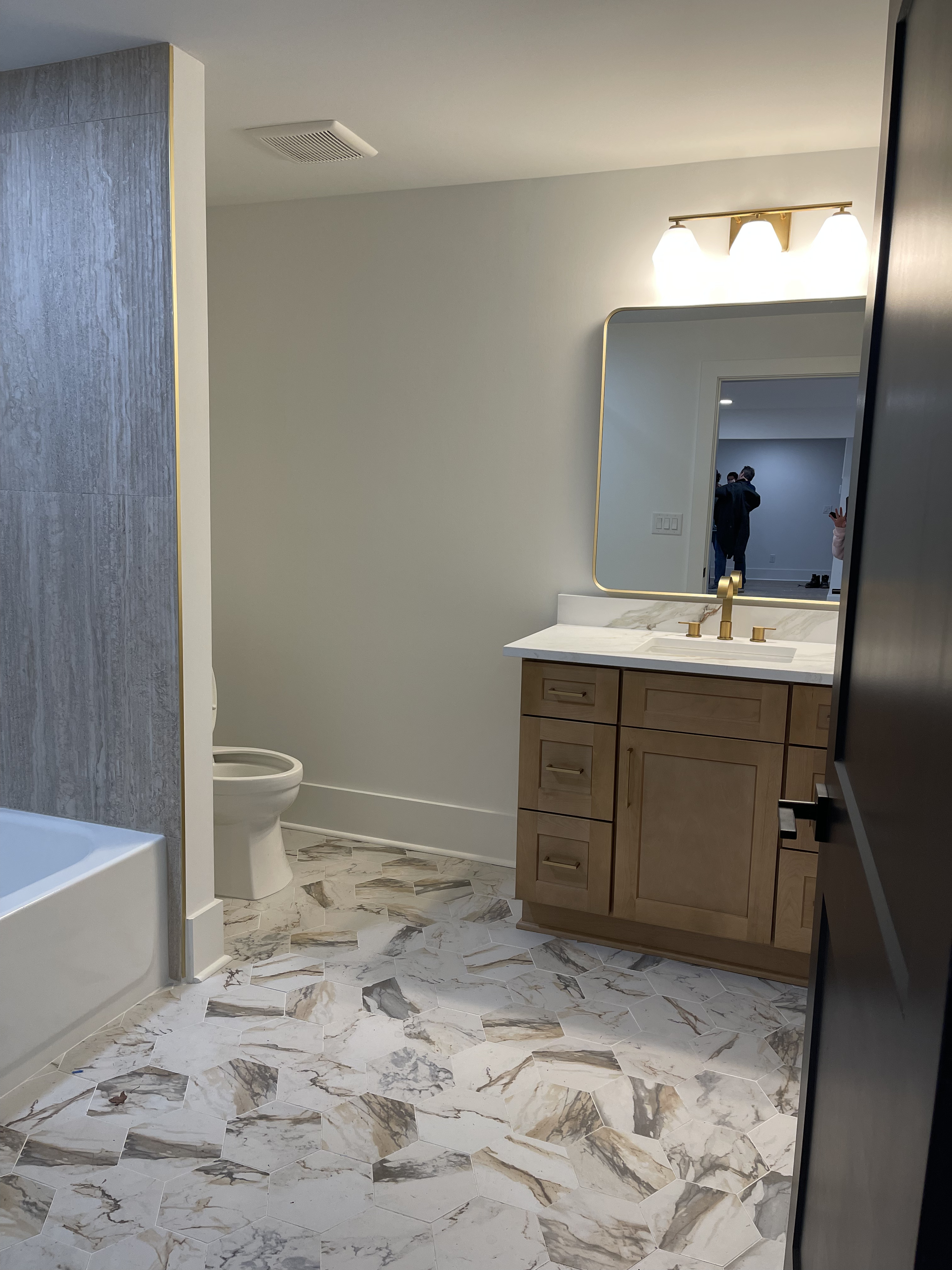 Woodstock basement remodel - bathroom with marble tile