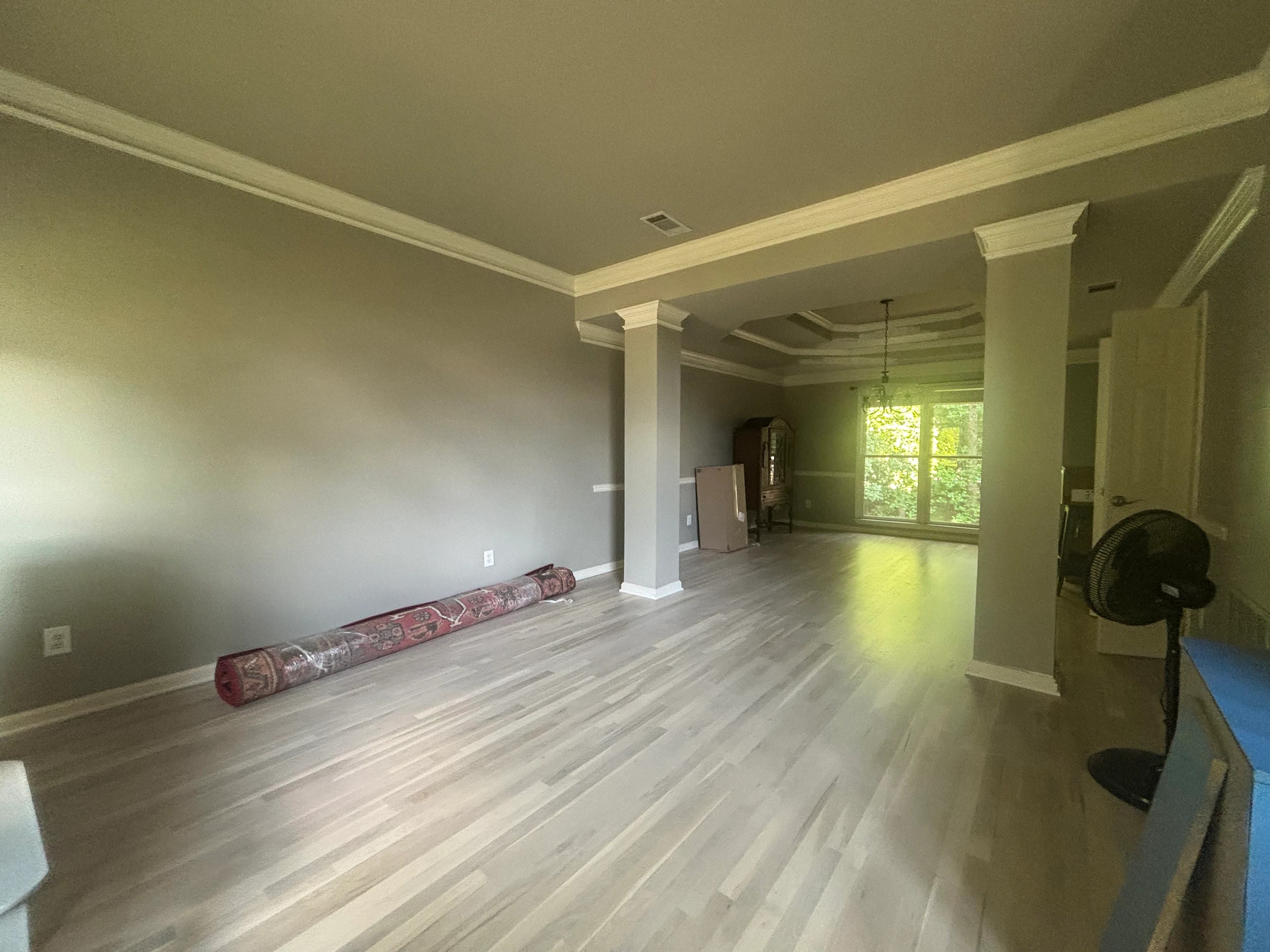 Wide-plank hardwood floors in open-concept living area